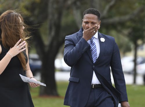 A mourner clutches his face after the funeral for Carmen Schentrup. (AAP)