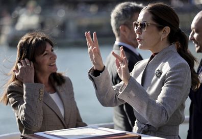 Paris mayor Anne Hidalgo, left, listens to Queen Mary of Denmark, Wednesday April 2, 2025 on a boat on the Seine river, in Paris. (Stephane de Sakutin, Pool via AP)