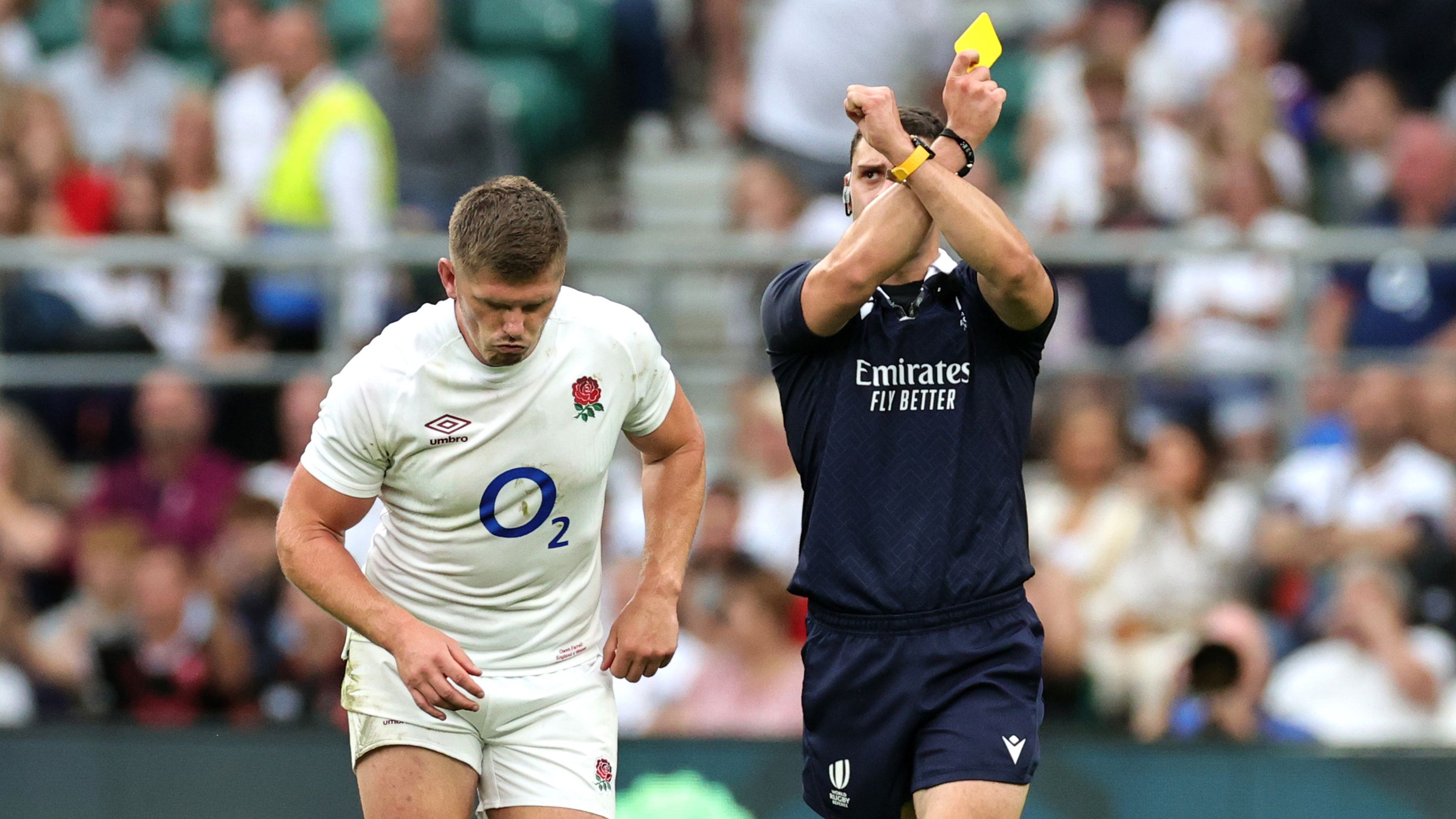 Owen Farrell receives a yellow card from referee Nika Amashukeli after a high tackle on Taine Basham of Wales.