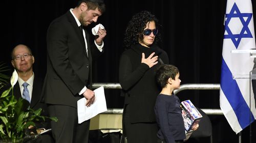 Jonathon Sherman cries as he and family members walk to the stage during a memorial service for his parents Barry and Honey Sherman in Mississauga, Ontario 