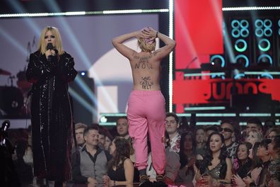 A protestor interrupts Avril Lavigne speaking onstage at the 2023 JUNO Awards at Rogers Place on March 13, 2023 in Edmonton, Canada. 