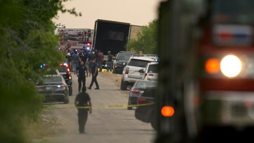 Body bags lie at the scene where a truck with multiple dead bodies was discovered in San Antonio.