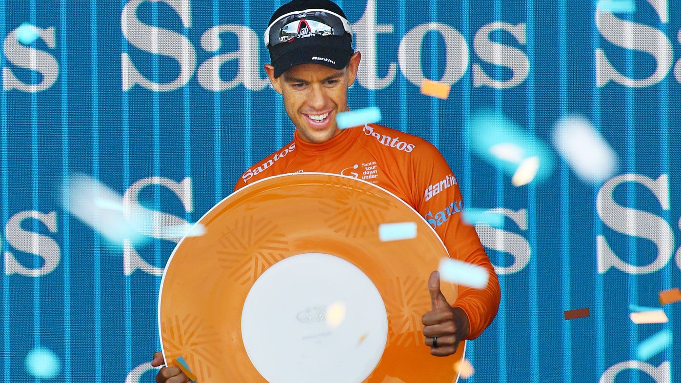 Richie Porte celebrates on the podium after winning the overall title after stage six of the Tour Down Under