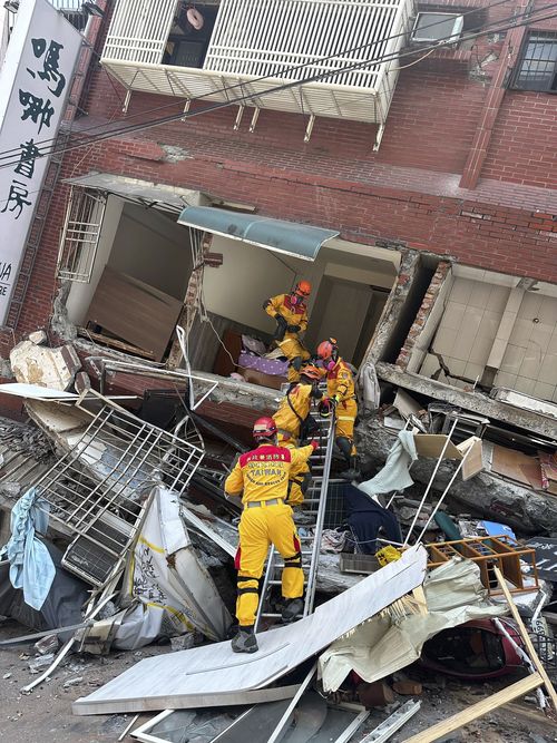 Members of a search and rescue team prepare to enter a leaning building in the aftermath of an earthquake in Hualien, eastern Taiwan on Wednesday, April 3, 2024.  