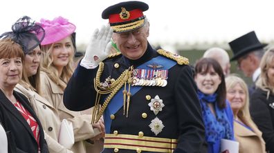 King Charles III waves as he meets guests after a ceremony to present new Standards and Colours to the Royal Navy, the Life Guards of the Household Cavalry Mounted Regiment, The King's Company of the Grenadier Guards and The King's Colour Squadron of the Royal Air Force at Buckingham Palace in London, Thursday April 27, 2023 