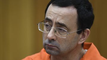 Larry Nassar listens as Rachael Denhollander gives her victim impact statement Friday, February 2, 2018. 