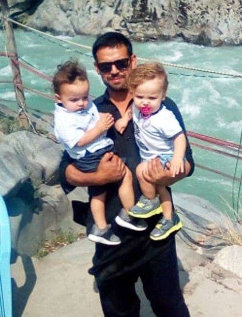 Mr Wangkimshen, pictured with his twin sons, Imran and Ibrahim.