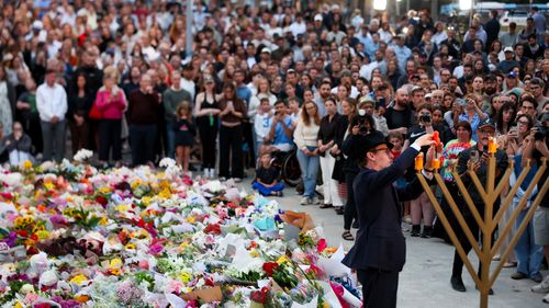 Mourners gather at a vigil to remember the victims of the Bondi Beach terror attack.