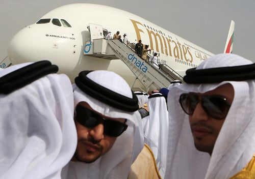 Emirati officials greet each other in front of an Emirates Airbus A380 on display during the opening day of the Dubai Airshow in Dubai, United Arab Emirates. (AAP)