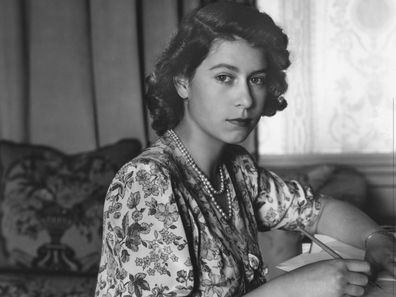 Queen Elizabeth II (as Princess Elizabeth) writing at her desk in Windsor Castle, Berkshire.  (Photo by Lisa Sheridan/Studio Lisa/Getty Images)