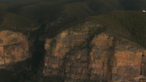 The huge cliff face where the injured climber fell.