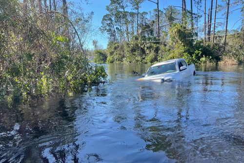 A car is submerged in flood water in North Port, Florida on Friday, September 30, 2022.