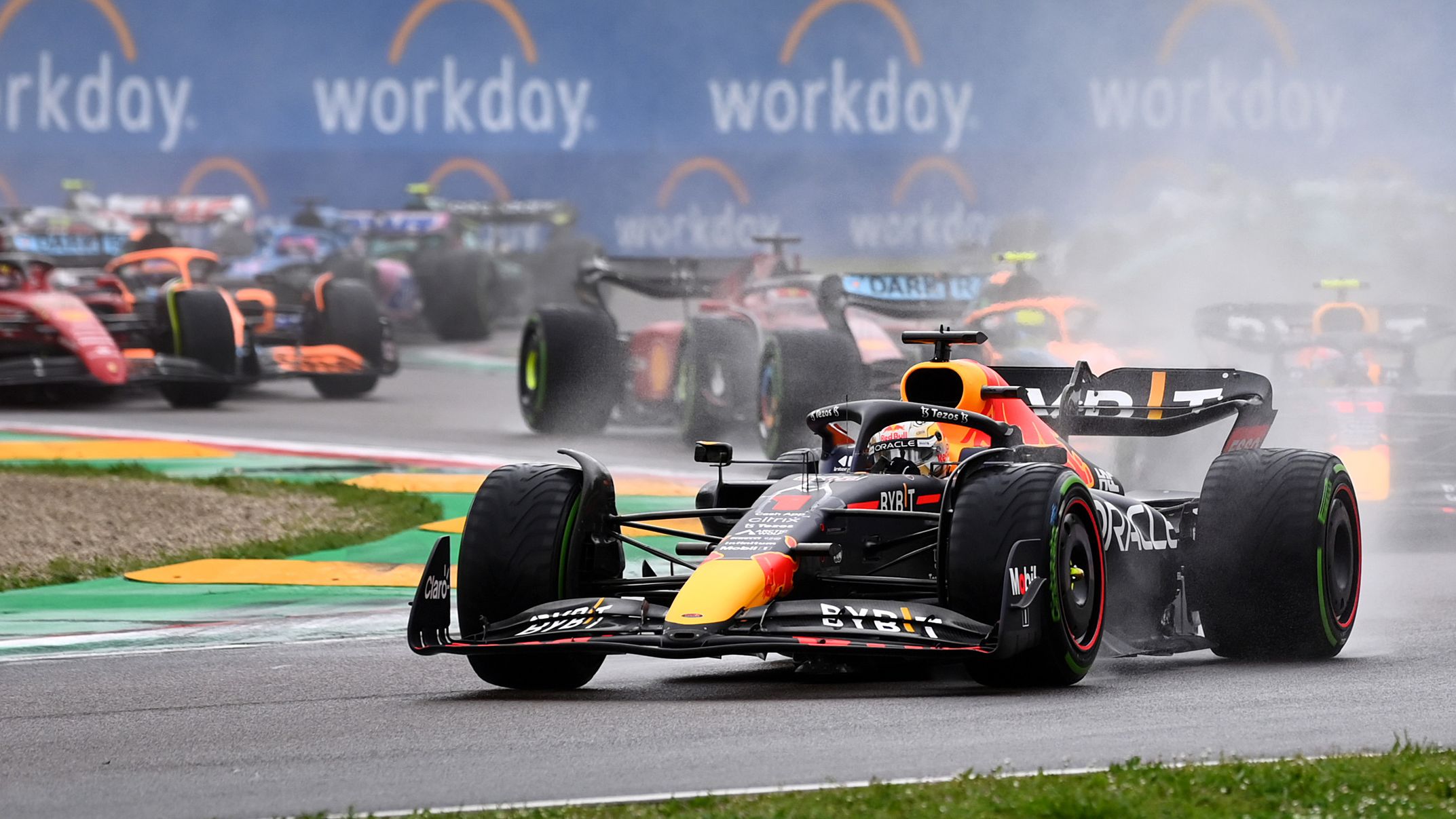 Max Verstappen of the Netherlands driving the (1) Oracle Red Bull Racing RB18 leads Sergio Perez of Mexico driving the (11) Oracle Red Bull Racing RB18 and the rest of the field into turn one at the start during the F1 Grand Prix of Emilia Romagna at Autodromo Enzo e Dino Ferrari.