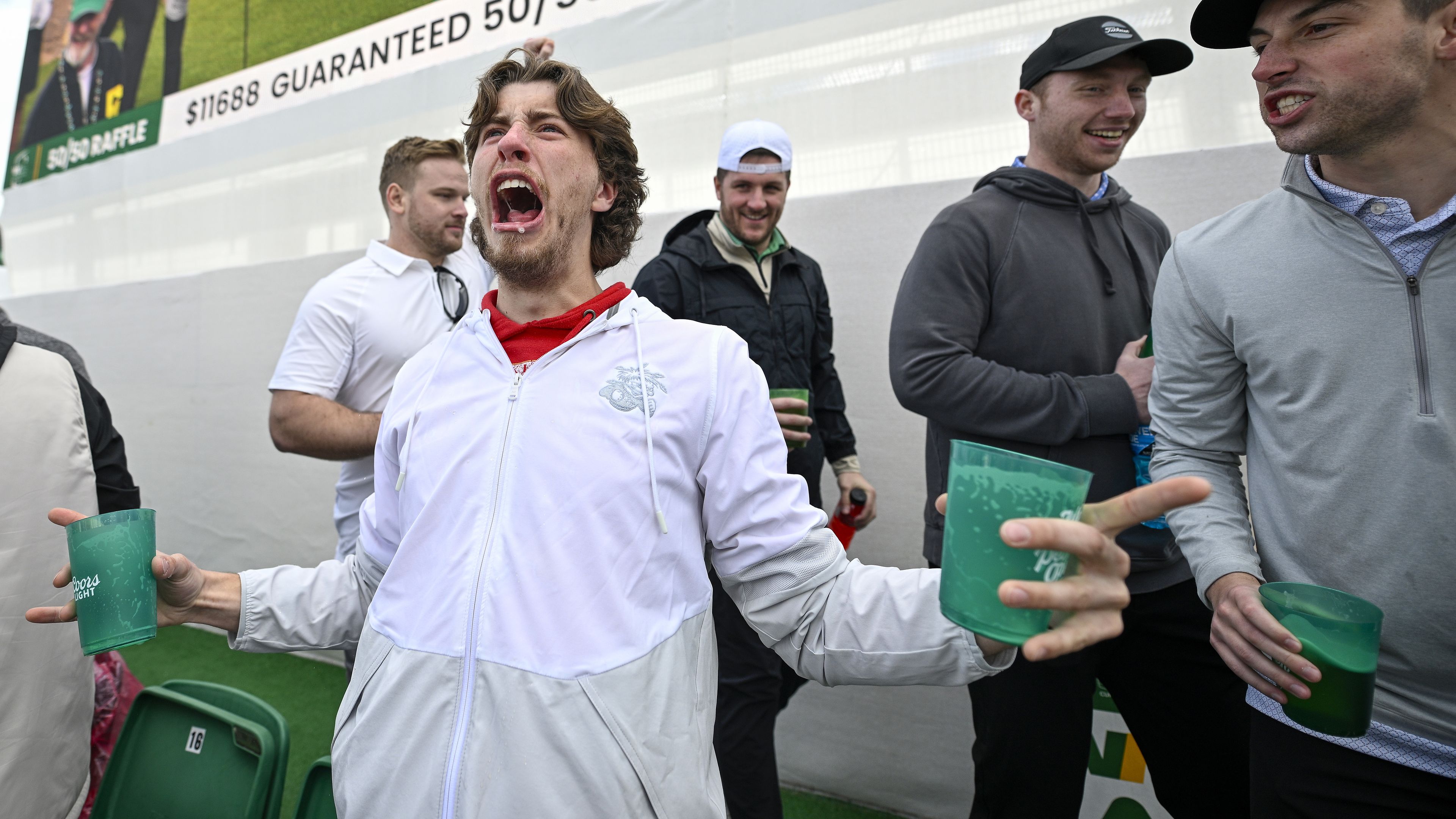 Fans celebrate on the 16th green.