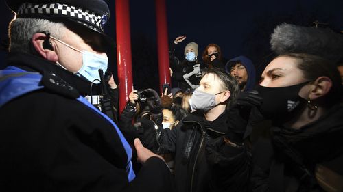 People react with police, in Clapham Common as people gather, despite the Reclaim These Streets vigil for Sarah Everard being officially cancelled.