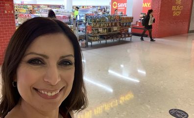 Jo Abi smiling out the front of The Reject Shop to compare prices