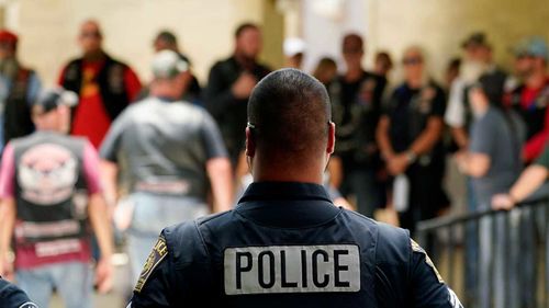 Police stand watch as guests arrive for the service for Nevaeh Bravo at Sacred Heart Catholic Church in Uvalde, Texas.