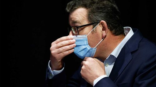 Victorian Prime Minister Daniel Andrews adjusts his mask during a press conference last year.