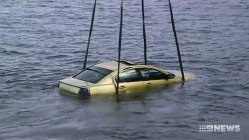 The Mitsubishi sedan reversed suddenly into a river.