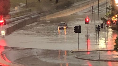 Local Amanda Langer came across a car stuck in floodwaters at the Eastland Intersection in Hobart.