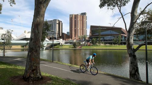 A man cyclists rides along the Torrens River on November 20, 2020 in Adelaide, Australia