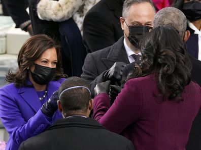 Vice President-elect Kamala Harris and her husband Doug Emhoff greet former President Barack Obama and former first lady Michelle Obama during the 59th Presidential Inauguration at the U.S. Capitol in Washington, Wednesday, Jan. 20, 2021. (AP Photo/Andrew Harnik)