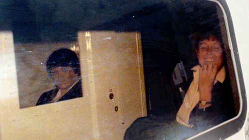 Rosemary West (left) sitting in a box within the police van that drove her from Winchster Crown Court, southern England, in 1995.