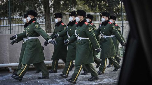 Police march wearing masks during a duty change on February 3, 2020 in Beijing, China.
