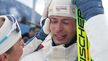 Sturla Holm Laegreid, of Norway, after winning bronze as teammate Ingrid Landmark Tandrevold comforts him after the men's 20-kilometer individual biathlon race at the 2026 Winter Olympics in Anterselva, Italy, Feb. 10, 2026.