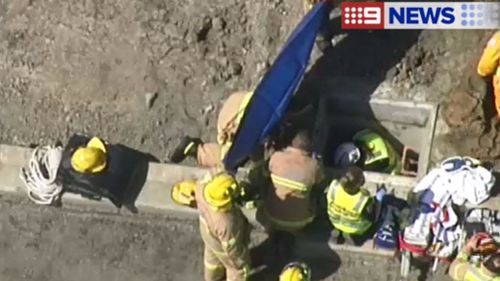 It is believed he became trapped just before 12.30pm. (9NEWS)
