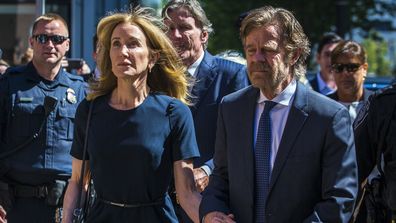 Felicity Huffman arrives with her husband William H. Macy at John Joseph Moakley US Courthouse in Boston on Sept. 13, 2019. She gets 14 days jail for her role in the college admissions scandal