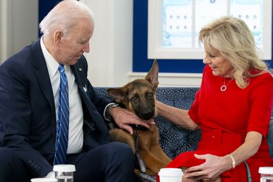 U.S. President Joe Biden, left, and First Lady Jill Biden pet their German Shepherd "Commander" while meeting virtually with United States service members serving around the world in the Eisenhower Executive Office Building in Washington, D.C., U.S., on Dec. 25, 2021. The service members represent the six service branches including the Army, Marine Corps, Navy, Air Force, Space Force, and Coast Guard. Photographer: Michael Reynolds/EPA/Bloomberg