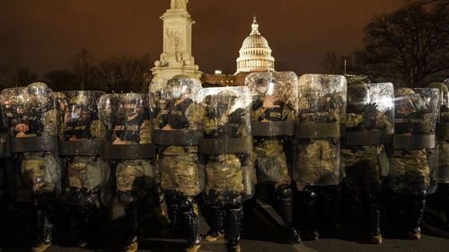 DC National Guard stand outside the Capitol.