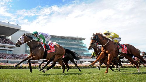 Jockey Michelle Payne, riding Prince Of Penzance, crosses the finish line to win the $6,000,000 Melbourne Cup. (Photo: AAP Image/Joe Castro)
