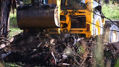 An excavator works in the backyard. (9NEWS)