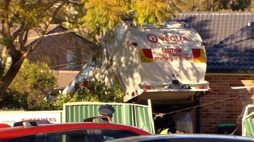 A garbage truck has smashed through a garden in Belrose, Sydney.