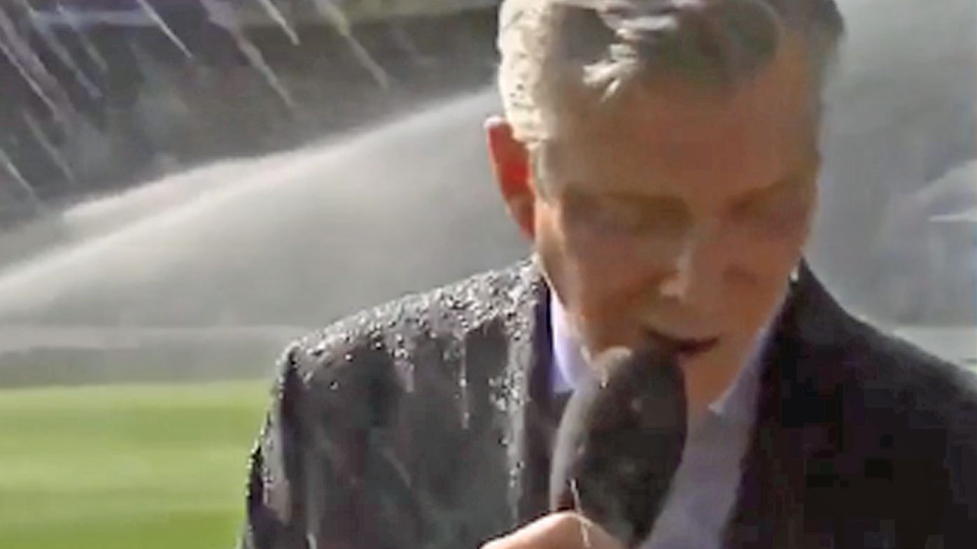 Michael Buffer gets drenched by sprinkler at Stamford Bridge, carries on like everything is fine