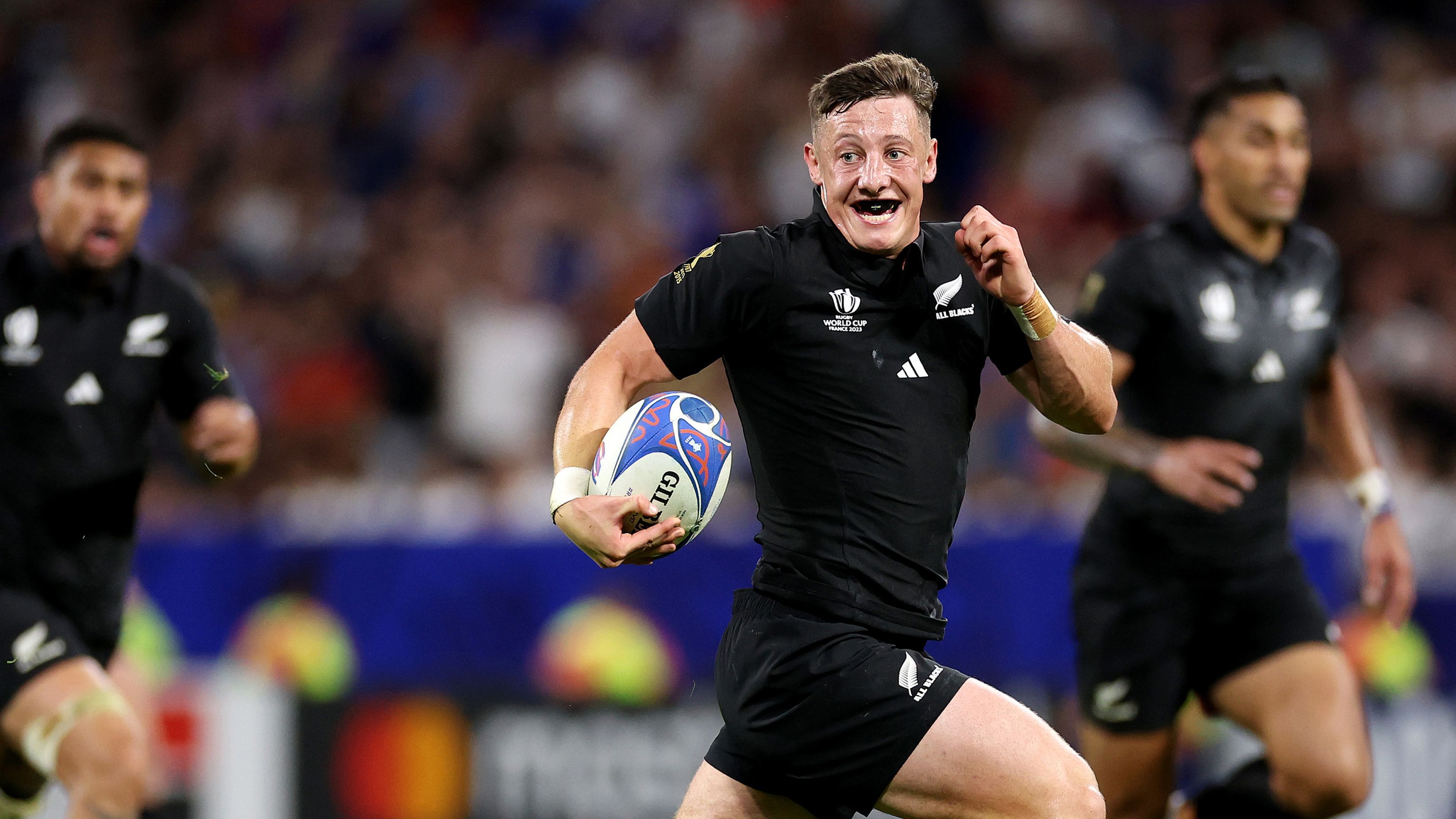 Cam Roigard of New Zealand runs with the ball.
