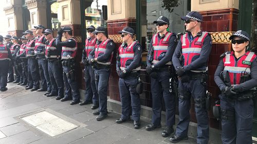 A large number of response police officers are waiting around the corner from the site. (9NEWS/Sean Davidson)