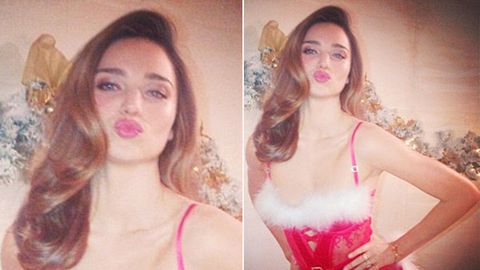 Santa's little hottie: Miranda Kerr poses in Christmas lingerie for fans