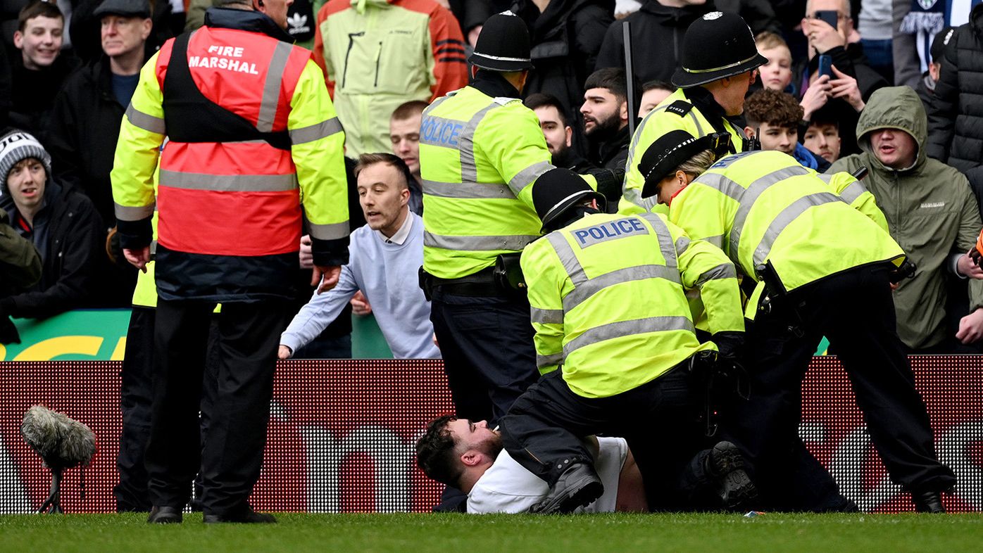 Local police officers attempt to stop a pitch invasion during the Emirates FA Cup Fourth Round match between West Bromwich Albion and Wolverhampton Wanderers at The Hawthorns on January 28, 2024 in West Bromwich, England. (Photo by Shaun Botterill/Getty Images)
