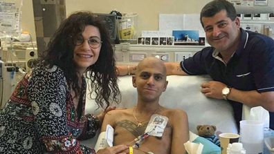 Mr Sylo, pictured with his parents in hospital in the US.