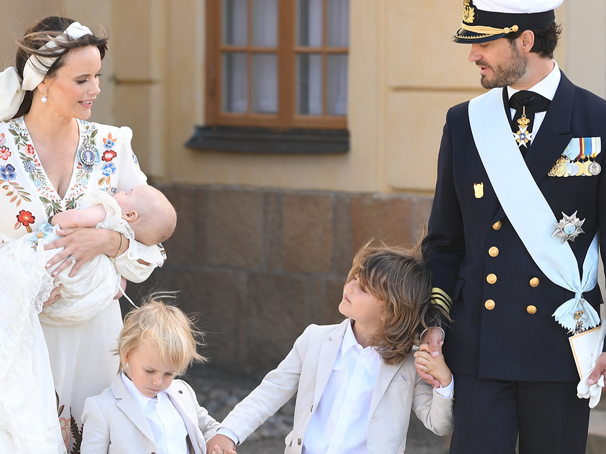 Sweden's Princess Madeleine, left holding Prince Nicolas stands