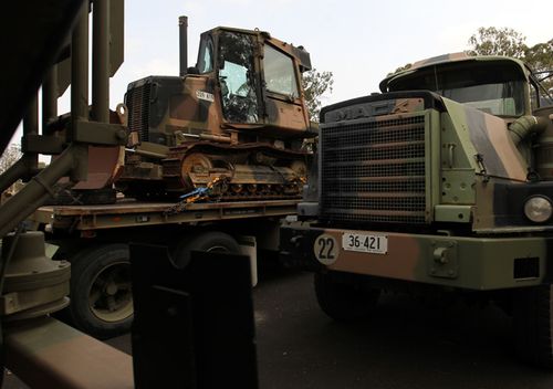 An Australian Defence Force MACK Truck and bulldozer to be used by Australian Army Reserve and Regular personnel