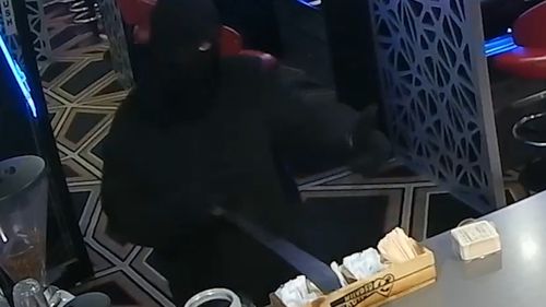 The robber was wearing a balaclava and armed with a machete.