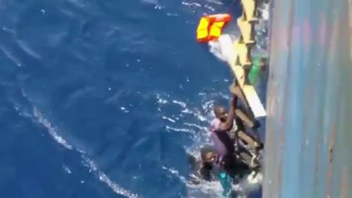 A passing cargo ship spotted the sinking boat and helped. (9NEWS)