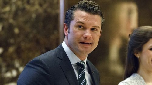 FILE - Pete Hegseth walks to an elevator for a meeting with President-elect Donald Trump at Trump Tower in New York, Dec. 15, 2016. (AP Photo/Evan Vucci, File)