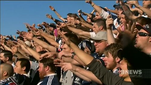 A number of football fans set off flares on the way to the ground. (9NEWS)