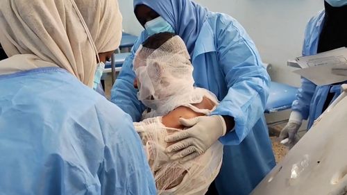 Hospital nurses treat a man injured in a fuel tanker explosion in Libya.