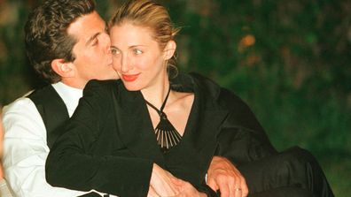 JFK Jr kisses his wife Carolyn Bessette Kennedy at a White House Correspondent's dinner in 1991